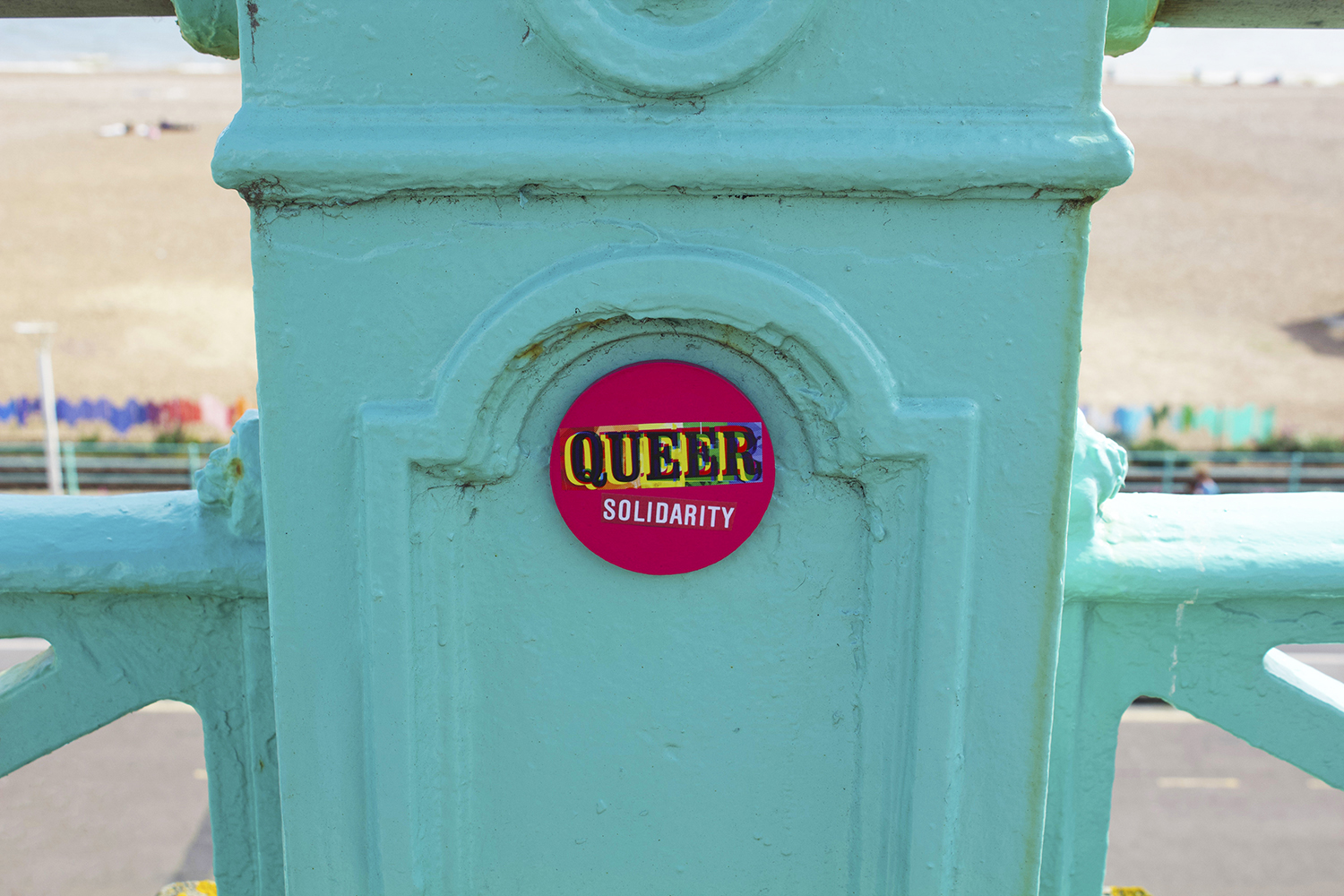 Queer badge on railing
